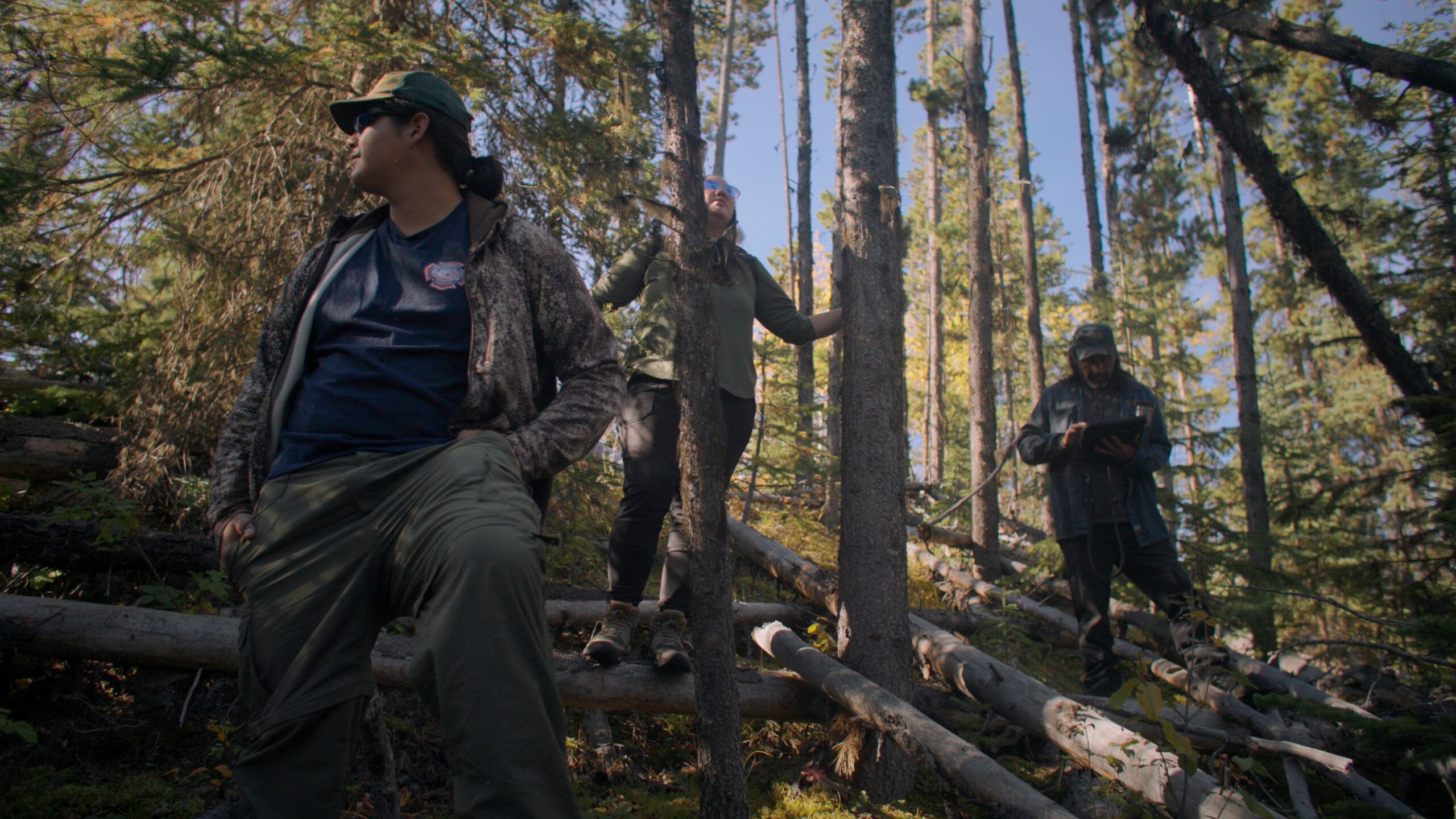 Photo: Salkuz First Nation environmental monitors James Thomas, Ashley Raphael, and Caleb Nome in the trees surrounding the Nechako.