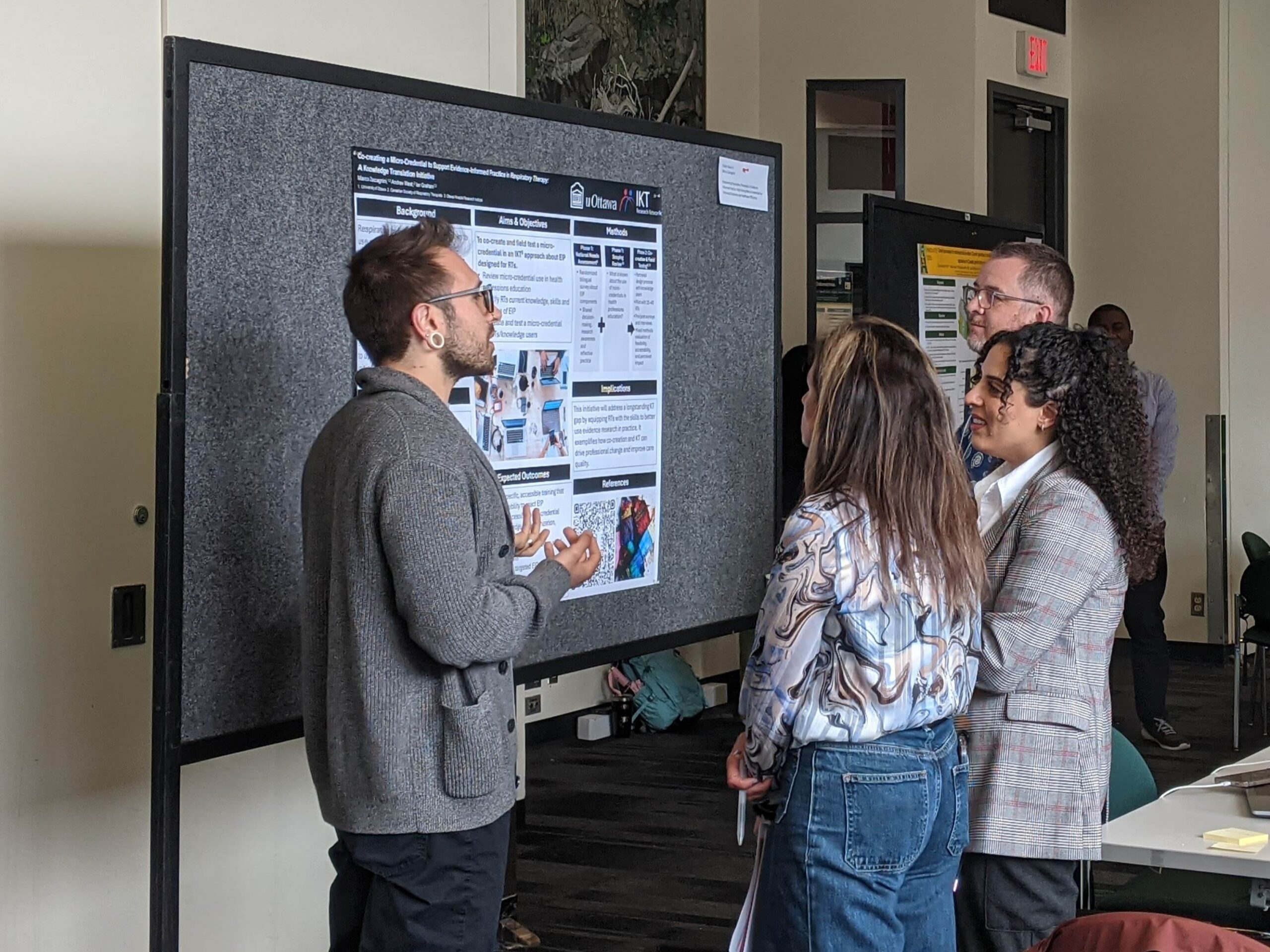 Knowledge Translation Canada Summers Institute 2025: Sharing knowledge in action, a participant discusses his research findings during the poster session.