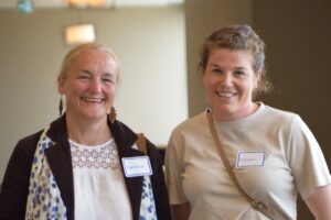 Two attendees smiling and standing together at the Made in the North event.