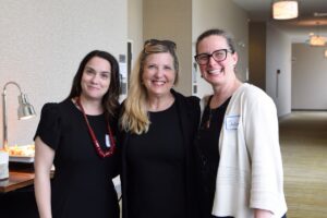 Three event attendees smiling together at the Made in the North event.
